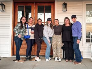 Lauren Coffman and the Brighton Ford affiliate team 1800NEWFORD.com celebrating their partnership on Lindsay Rowe's porch. 